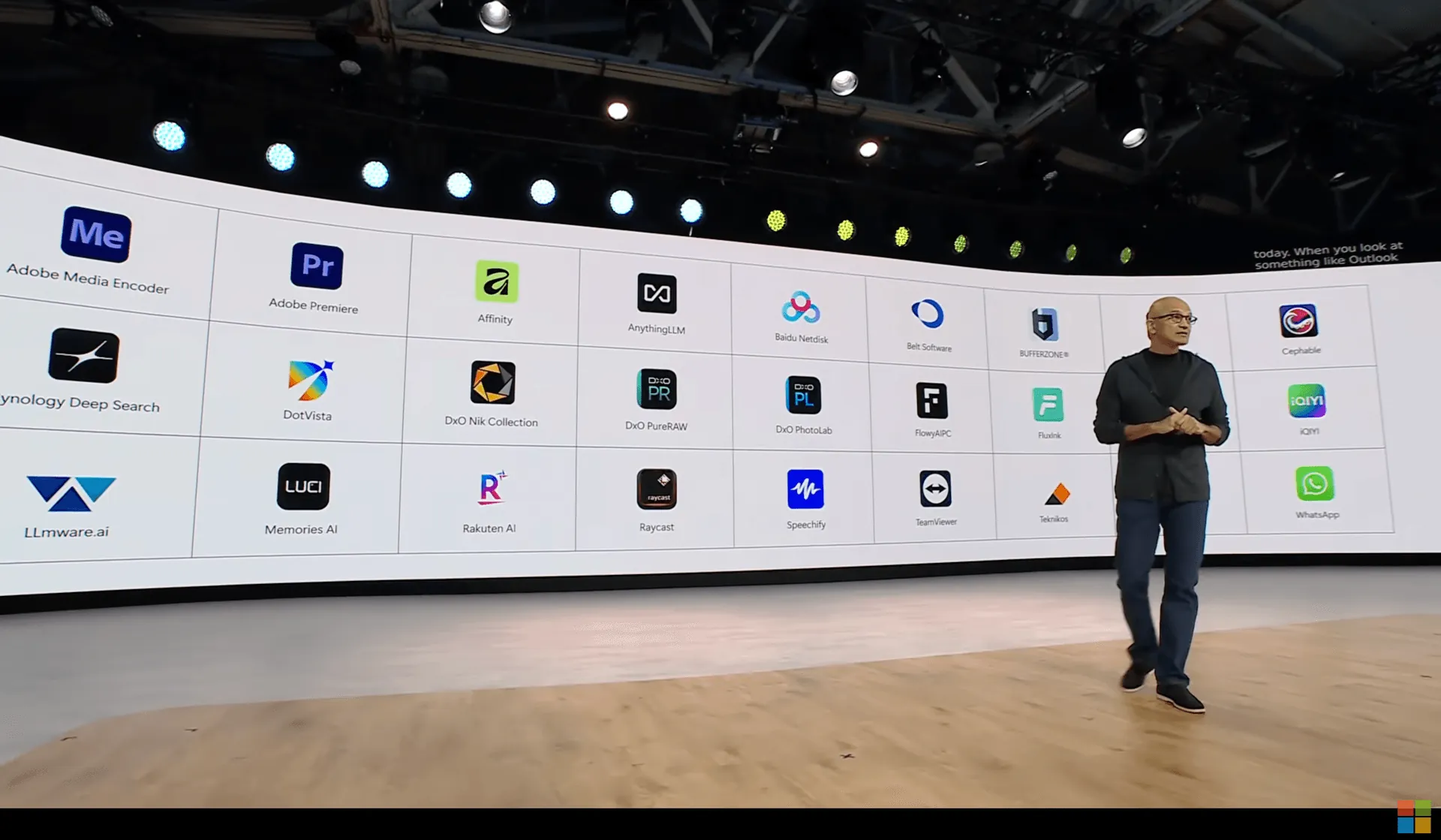 Satya Nadella on stage at Microsoft Build 2026 in front of a wall of Windows apps, with AnythingLLM in the center